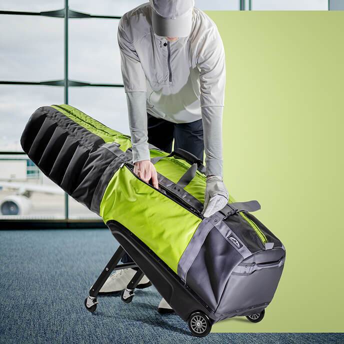 Person in airport with Sun Mountain ClubGlider Meridian golf travel bag