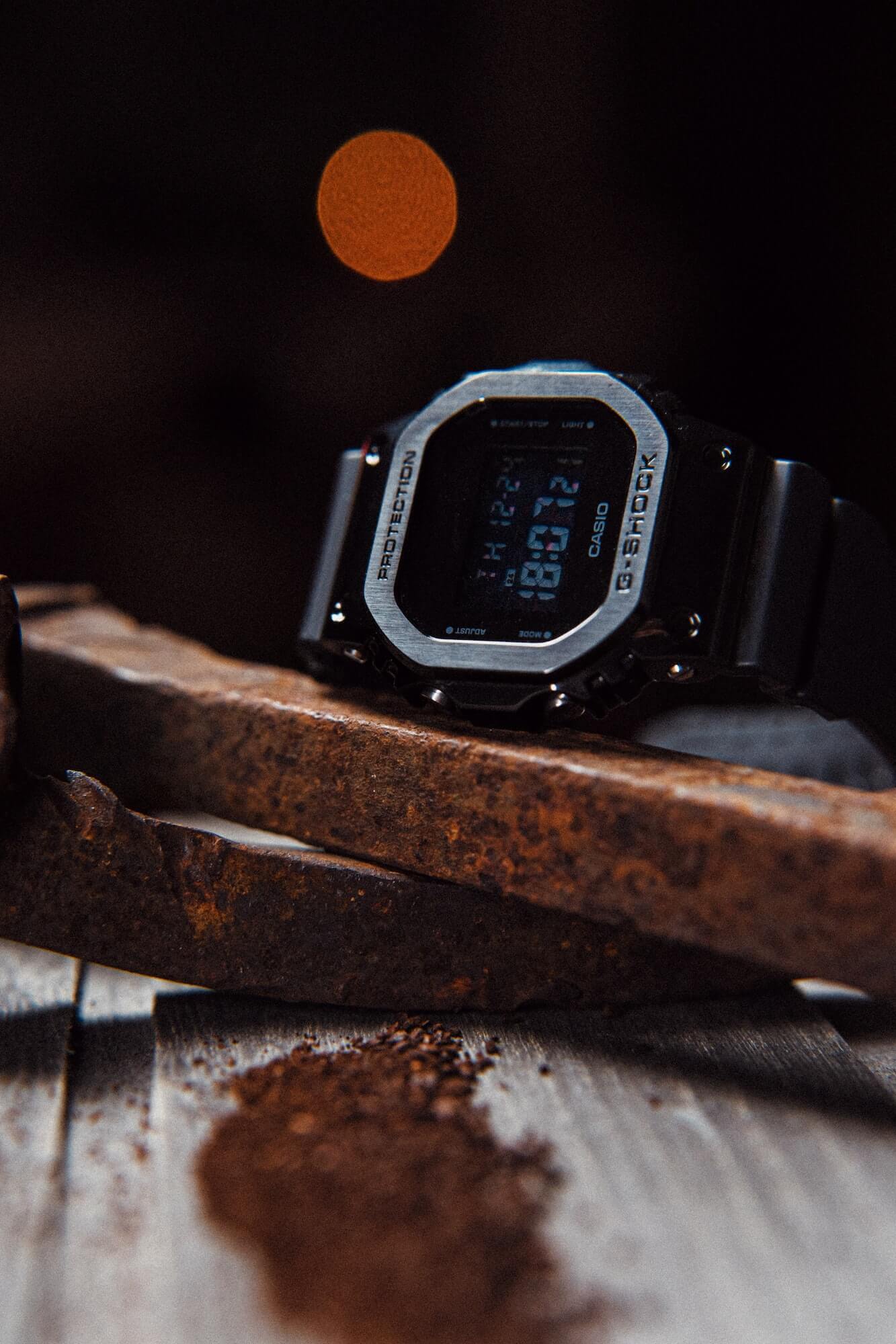 Casio G-Shock digital watch rests atop a rusty metal tool